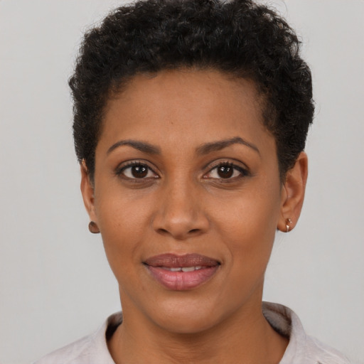 Joyful latino young-adult female with short  black hair and brown eyes
