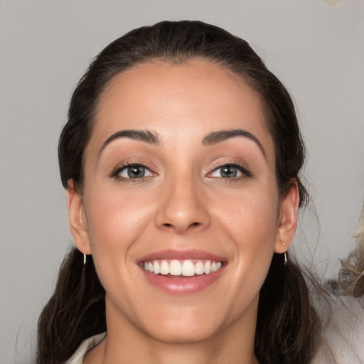 Joyful white young-adult female with medium  brown hair and brown eyes