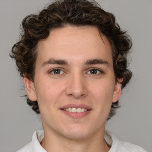 Joyful white young-adult male with medium  brown hair and brown eyes