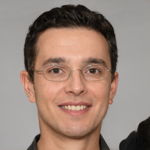 Joyful white adult male with short  brown hair and brown eyes