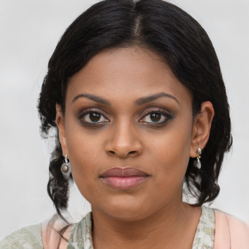 Joyful black young-adult female with medium  brown hair and brown eyes