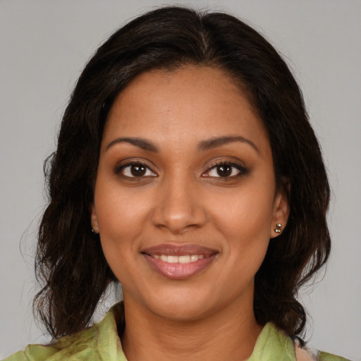 Joyful black young-adult female with medium  brown hair and brown eyes