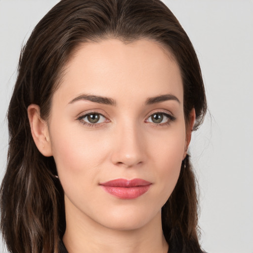 Joyful white young-adult female with long  brown hair and brown eyes