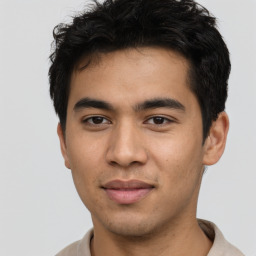 Joyful asian young-adult male with short  black hair and brown eyes