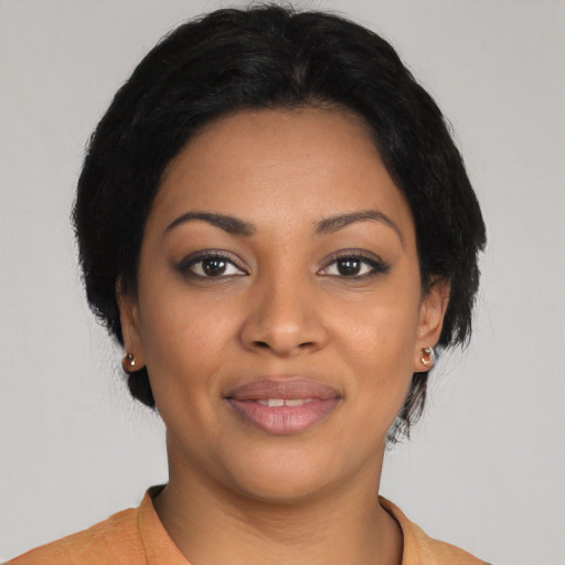 Joyful latino young-adult female with short  black hair and brown eyes