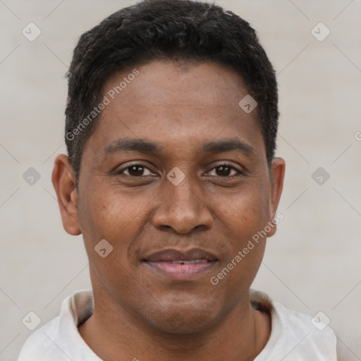 Joyful latino young-adult male with short  brown hair and brown eyes