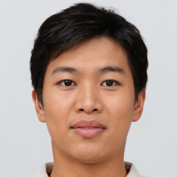 Joyful asian young-adult male with short  brown hair and brown eyes