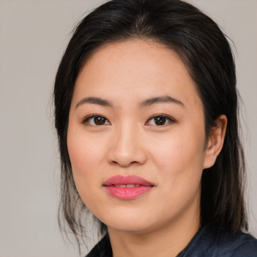 Joyful asian young-adult female with medium  brown hair and brown eyes