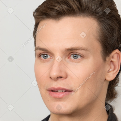 Joyful white young-adult male with medium  brown hair and grey eyes