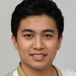Joyful asian young-adult male with short  black hair and brown eyes