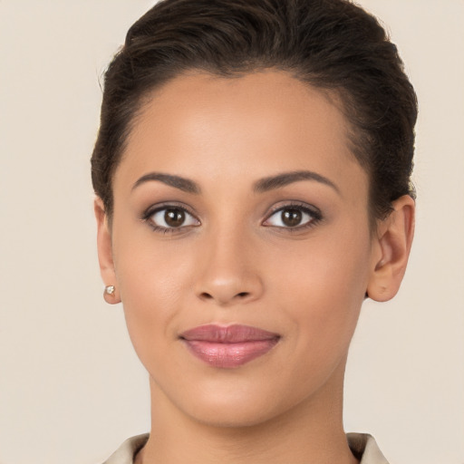 Joyful latino young-adult female with short  brown hair and brown eyes