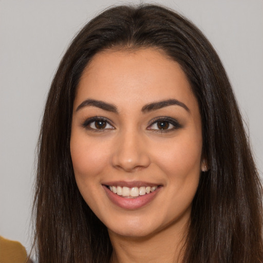 Joyful white young-adult female with long  brown hair and brown eyes