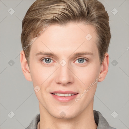 Joyful white young-adult male with short  brown hair and grey eyes