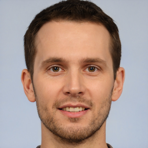 Joyful white young-adult male with short  brown hair and brown eyes