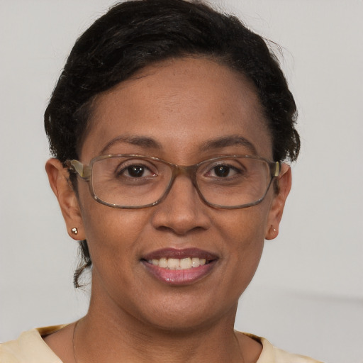 Joyful black adult female with short  brown hair and brown eyes