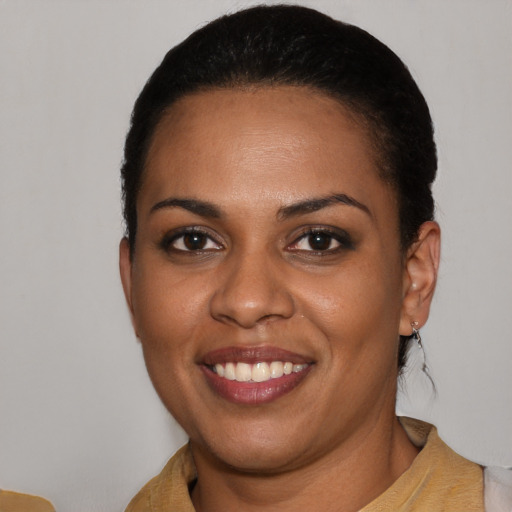 Joyful black young-adult female with short  brown hair and brown eyes