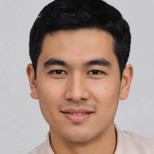 Joyful asian young-adult male with short  black hair and brown eyes