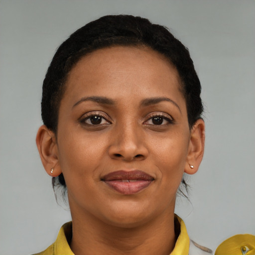 Joyful black young-adult female with short  brown hair and brown eyes