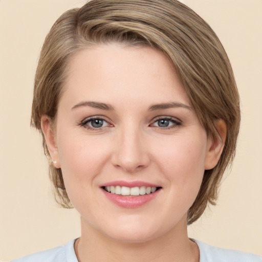 Joyful white young-adult female with medium  brown hair and green eyes