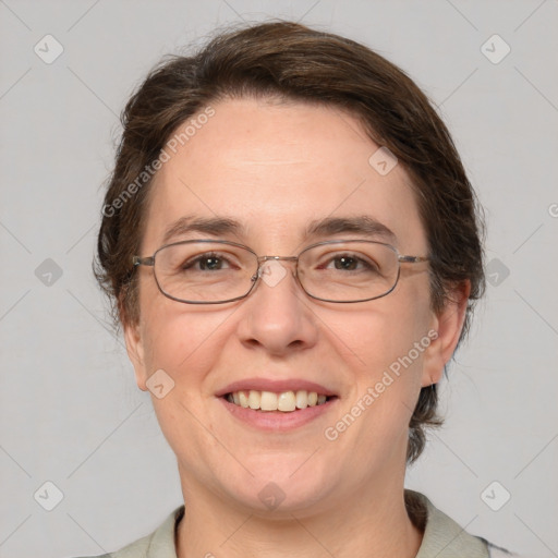 Joyful white adult female with medium  brown hair and grey eyes