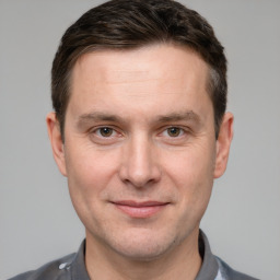 Joyful white adult male with short  brown hair and grey eyes