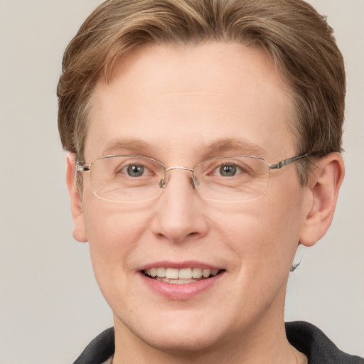 Joyful white adult male with short  brown hair and grey eyes