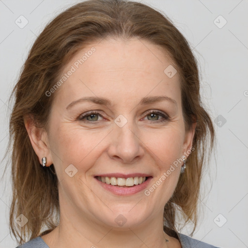 Joyful white adult female with medium  brown hair and grey eyes