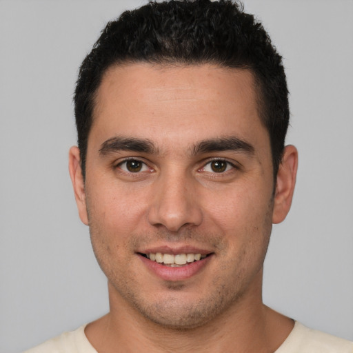 Joyful white young-adult male with short  brown hair and brown eyes