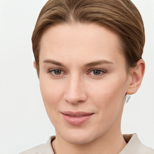 Joyful white young-adult female with short  brown hair and grey eyes