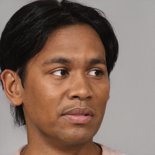 Joyful asian adult male with short  black hair and brown eyes