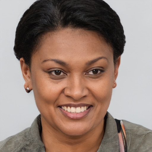 Joyful latino young-adult female with short  brown hair and brown eyes