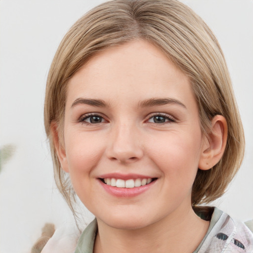 Joyful white young-adult female with medium  brown hair and blue eyes