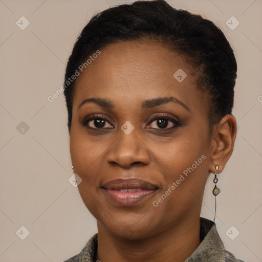 Joyful black young-adult female with short  black hair and brown eyes