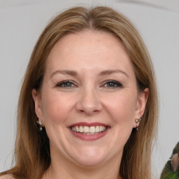 Joyful white adult female with medium  brown hair and grey eyes