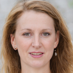 Joyful white young-adult female with long  brown hair and blue eyes