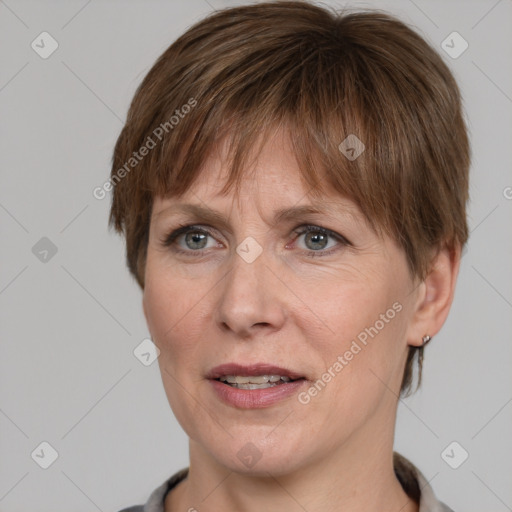 Joyful white adult female with short  brown hair and grey eyes