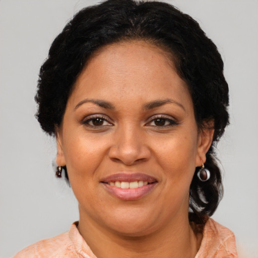 Joyful latino adult female with medium  brown hair and brown eyes