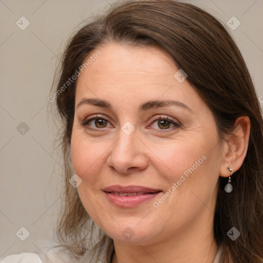 Joyful white adult female with long  brown hair and brown eyes