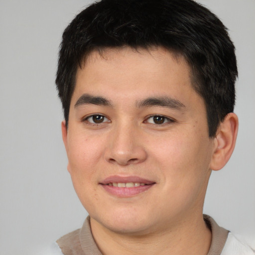 Joyful asian young-adult male with short  brown hair and brown eyes