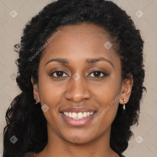 Joyful black young-adult female with long  brown hair and brown eyes