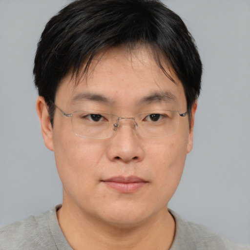 Neutral asian adult male with short  brown hair and brown eyes