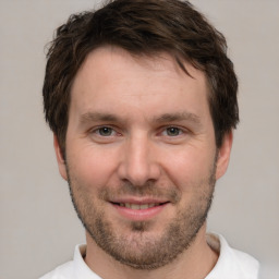 Joyful white young-adult male with short  brown hair and brown eyes