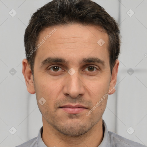 Joyful white adult male with short  brown hair and brown eyes