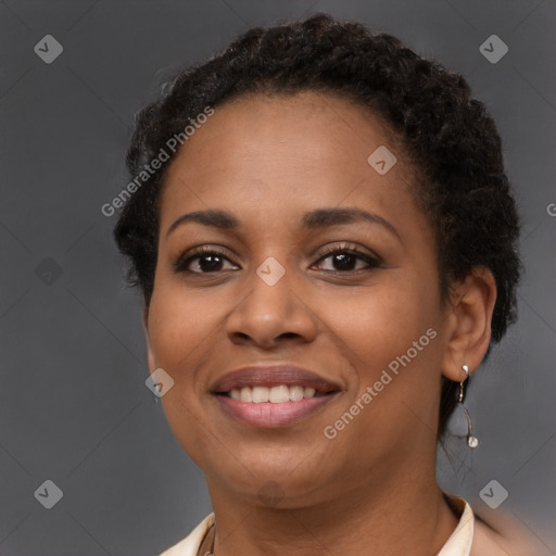 Joyful black young-adult female with short  brown hair and brown eyes