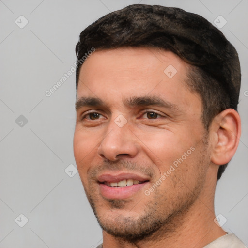 Joyful white young-adult male with short  black hair and brown eyes