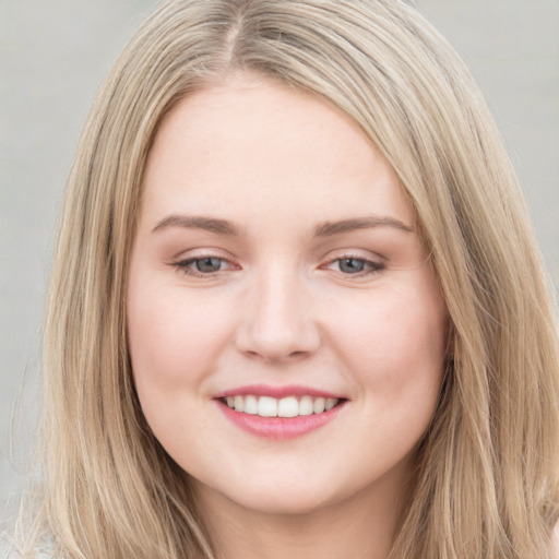 Joyful white young-adult female with long  brown hair and blue eyes