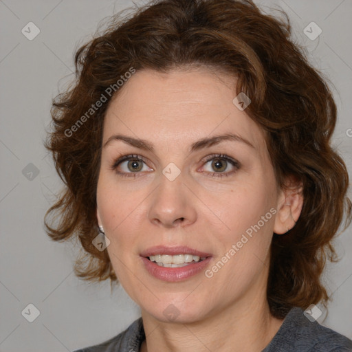 Joyful white adult female with medium  brown hair and blue eyes