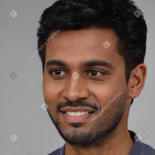 Joyful black young-adult male with short  black hair and brown eyes