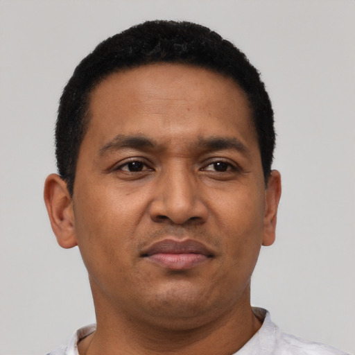 Joyful latino adult male with short  black hair and brown eyes