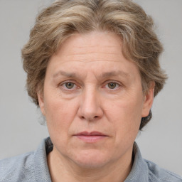 Joyful white middle-aged female with short  brown hair and blue eyes